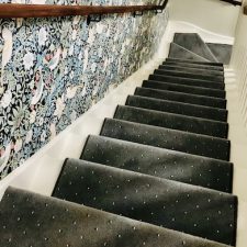 View down a staircase fitted with battleship grey dotted carpet by Sargeant Carpets.