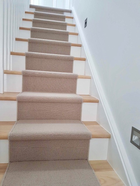 Beige carpet with whipped edge runners fitted by Sargeant Carpets in a beach house.