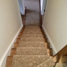 A staircase with brown patterned heavy domestic carpet by Hugh Mackay in Country Oak from the Nature's Own range. Whipped edges around perimeter.