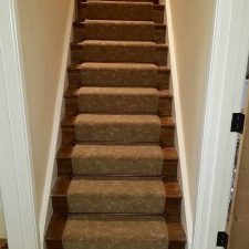 Stairs fitted with brown patterned carpet fitted over Duralay's Duralay King underlay with antique bronze solid stair rods.