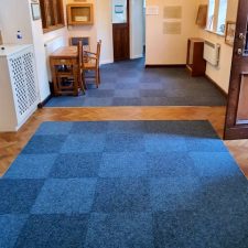 Sapphire coloured carpet tiles fitted in a chequerboard pattern at Rustington Methodist Church from the Felkirk heavy contract velour range. Made from polypropylene pile.