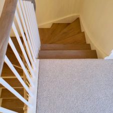 View down a staircase fitted with wool loop carpet by Edel Telenzo Carpets