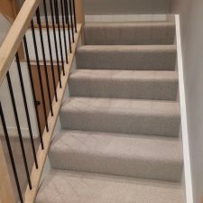 Beige low level wool loop carpet fitted on stairs over Cloud 9 Cirrus underlay