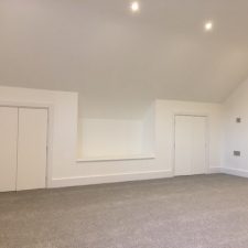 Grey colour carpet from Cormar Carpet Company fitted in a bedroom with sloping ceilings and white walls.