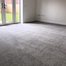 Lounge fitted with a grey coloured carpet.
