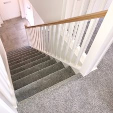 Stairs fitted with a grey, Holywell Tin coloured carpet by Cormar Carpet Company. Made from Excellon Polypropylene, a twist pile carpet fitted over Tredaire softwalk pu foam underlay by Sargeant Carpets.