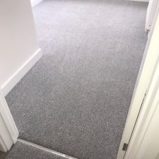 Bedroom fitted with a grey, Holywell Tin coloured carpet by Cormar Carpet Company. Made from Excellon Polypropylene, a twist pile carpet fitted over Tredaire softwalk pu foam underlay by Sargeant Carpets.