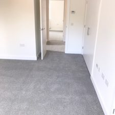 Bedroom fitted with a grey, Holywell Tin coloured carpet by Cormar Carpet Company. Made from Excellon Polypropylene, a twist pile carpet fitted over Tredaire softwalk pu foam underlay by Sargeant Carpets.