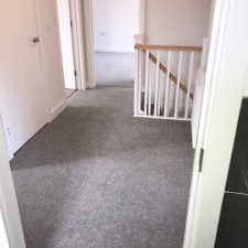 Landing fitted with a grey, Holywell Tin coloured carpet..