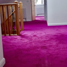 View of a landing and into a bedroom fitted with a deep Ruby carpet as part of an HD Developments Ltd project