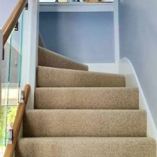 View up a staircase fitted with a beige Cormar Carpet from the Malabar range in Llama