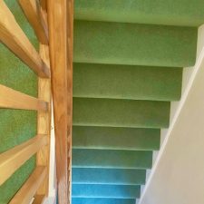 View of stairs fitted with a green carpet by Adam Carpets in Fine Worcester Twist, Fladbury Fern colour.