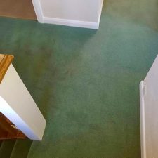 View of a landing fitted with a green carpet by Adam Carpets in Fine Worcester Twist, Fladbury Fern colour.
