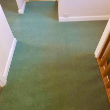 View of a landing fitted with a green carpet by Adam Carpets in Fine Worcester Twist, Fladbury Fern colour.