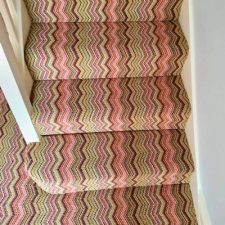 View of stairs fitted with a zig zag stripy carpet by Hugh Mackay from their deco collection in Notting Hill