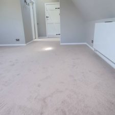 View of a loft room with angled, vaulted ceiling and beige carpet in Faux Pearl by Lano from their Smartstrand Super Freedom range.