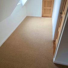 View of landing with a beige carpet by Ulster Carpets from their Grange Wilton range in Spelt.