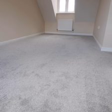 An empty bedroom fitted with a grey carpet from the Primo Naturals range by Cormar Carpets