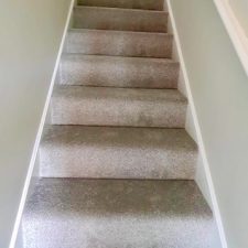 View up a flight of stairs fitted with a grey carpet by Cormar Carpets