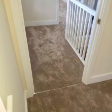 View out of a bedroom onto a landing fitted with a beige carpet from the Sensations range by Cormar Carpets in alpine stone