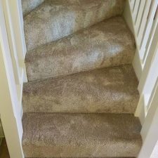 View of stair treads fitted with a beige carpet from the Sensations range by Cormar Carpets in alpine stone