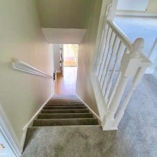 View from landing down stairs fitted with grey westmorland carpet by Sargeant Carpets