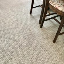 View of a dining room floor fitted with a domestic wool velvet patterened carpet treated with moth and dust mite repellant