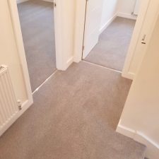 View into two bedrooms fitted with beige bleach cleanable polypropylene twist pile carpet from the Cormar Carpets Apollo Plus range in Homerton Grey