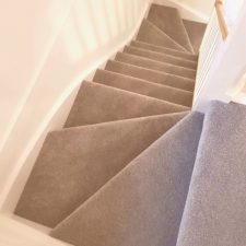 View down a staircase fitted with beige bleach cleanable polypropylene twist pile carpet from the Cormar Carpets Apollo Plus range in Homerton Grey
