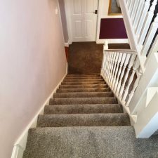 View down a flight of stairs fitted with PSolution dyed Ivivo nylon Saxony, Easy clean bleach cleanable, heavy duty Heather effect pile carpet.