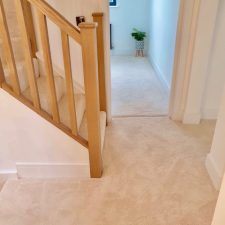 View of a landing fitted with a beige, thick polyester saxony pile carpet, in Somerset Ash from Cormar Carpets