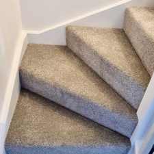 View of some stairs fitted with a Polypropylene heather effect twist pile carpet with easy clean bleach cleanable pile.