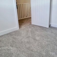 View of a floor fitted with a Polypropylene heather effect twist pile carpet with easy clean bleach cleanable pile.