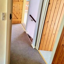View of a corridor floor fitted with beige Westex Carpets wool twist pile carpet from the Ultima Twist range in Fossil.