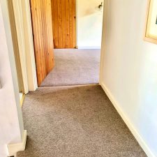 View of a corridor floor fitted with beige Westex Carpets wool twist pile carpet from the Ultima Twist range in Fossil.