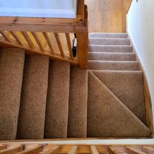 View down stairs fitted with a wool Berber Fleck twist pile carpet from Adam Carpets' Kasbah Twist range in Kazan