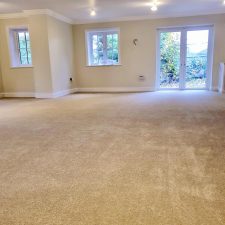View of a living room fitted with a polypropylene twist pile carpet, bleach cleanable tri-coloured yarn.