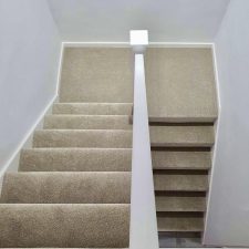 View down stairs fitted with a beige polypropylene tri-colour twist pile carpet.