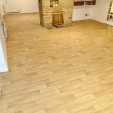 Living room fitted with safety flooring in a heavy duty Heterogeneous vinyl in American Oak