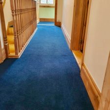 A landing fitted with a blue 80% wool twist carpet by Victoria Carpets in Eclipse colour