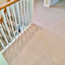 A landing fitted with a light beige 80% wool 20% nylon twist, extra heavy domestic, moth proof carpet