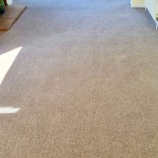 A living room fitted with a beige wool twist, extra heavy carpet by Cormar Carpets.