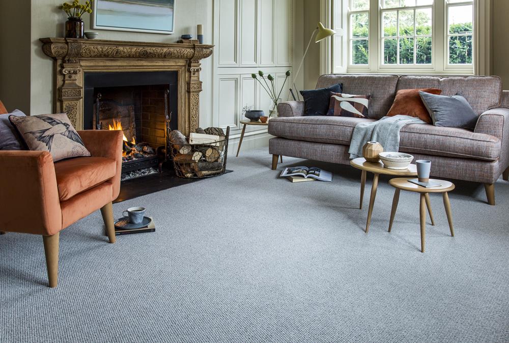 Living room with sofa, open fire, tables and occasional chair with a grey malabar tungsten moth resistant carpet