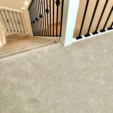 View down stairs fitted with pale grey wool twist, one tenth gauge carpet pile.