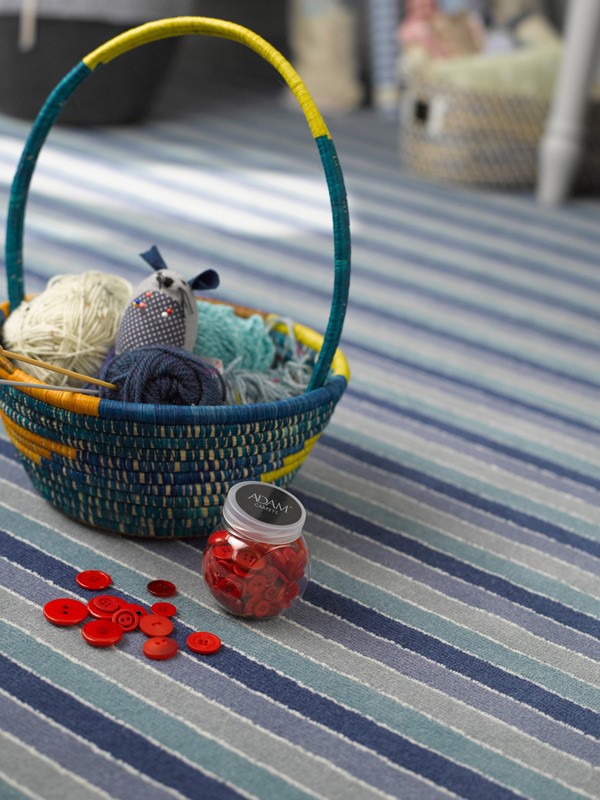 Basket with wool and buttons on a stripy carpet from the Deckchair range by Adam Carpets