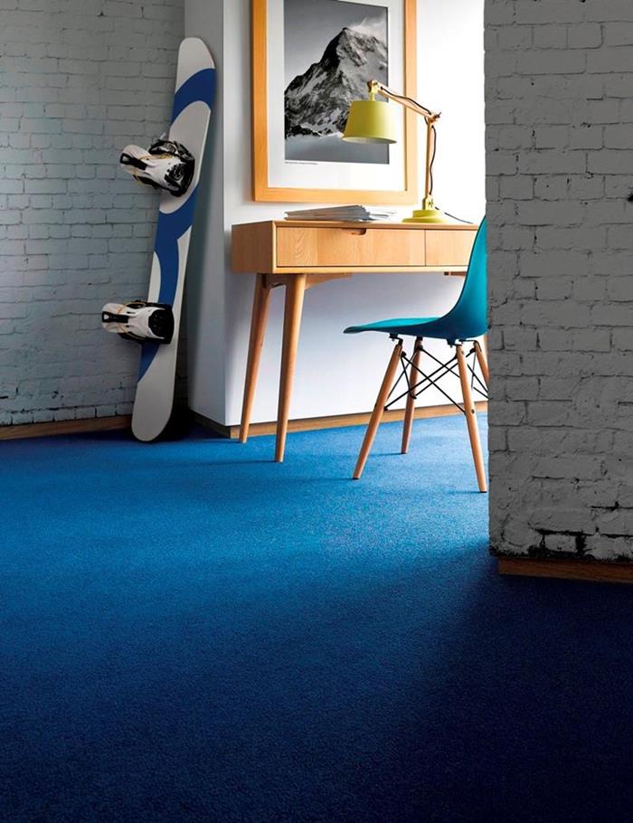 Living room fitted with a vibrant blue carpet from the Fine Worcester Twist range by Adam Carpets