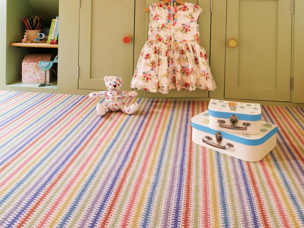 Bright and cheerful child's bedroom fitted with a stripy carpet from the Panache range by Adam Carpets