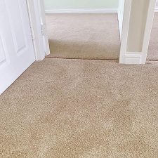 Beige polypropylene Saxony carpet fitted in living rooms and a hallway