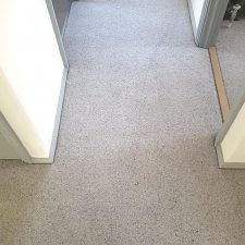 View of a landing floor fitted with a wool berber twist, moth resistant grey carpet.