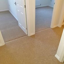 View into bedrooms from a landing, all rooms carpeted with a honey-coloured polypropylene twist carpet.